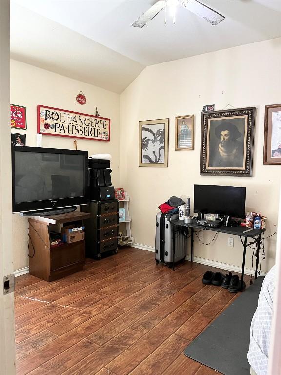 living room featuring vaulted ceiling, hardwood / wood-style flooring, and ceiling fan