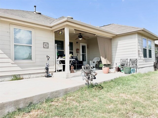 back of property with a patio area, a lawn, and ceiling fan