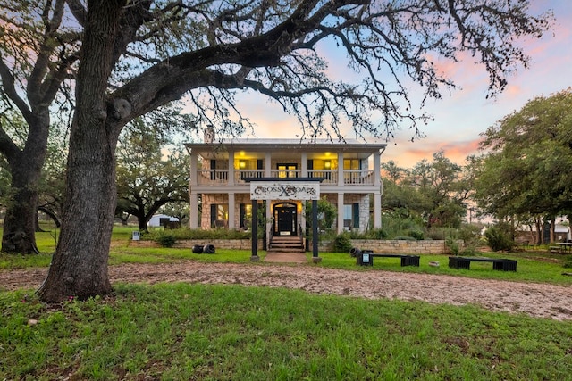 view of front facade featuring a balcony and a porch