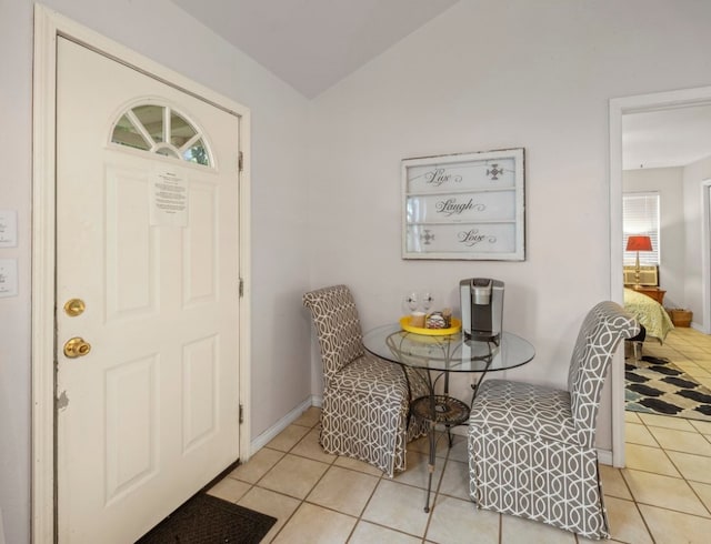 foyer entrance with light tile patterned floors and a wealth of natural light