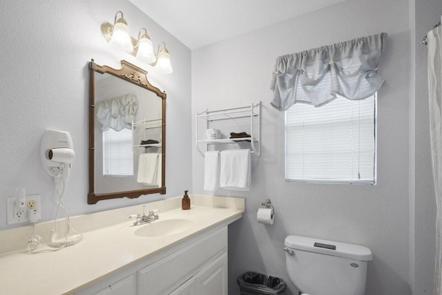 full bath featuring vanity and toilet