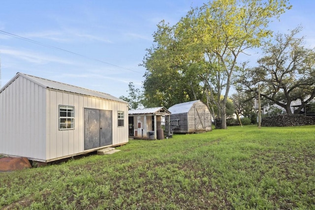 view of yard featuring a storage unit, exterior structure, and an outbuilding