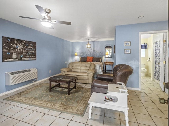 living area featuring baseboards, heating unit, ceiling fan, and tile patterned flooring