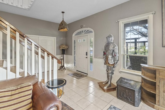 tiled foyer featuring stairway