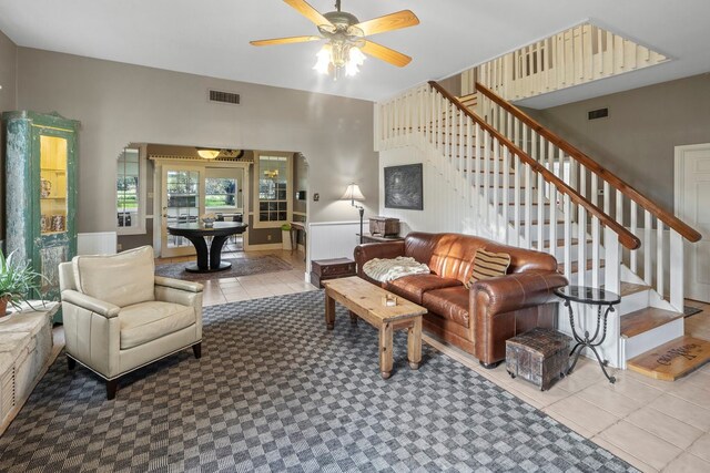 tiled living room with ceiling fan