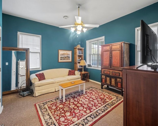 carpeted living area featuring ceiling fan