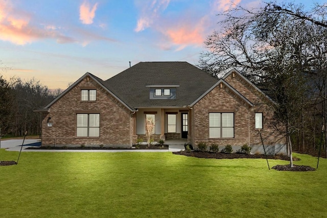 view of front facade with a front yard and brick siding