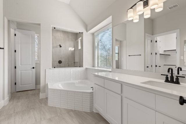 full bath featuring visible vents, lofted ceiling, walk in shower, vanity, and a bath