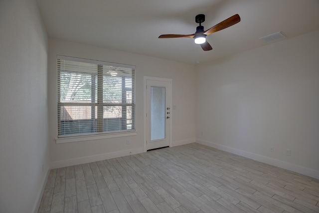 spare room with ceiling fan and light wood-type flooring