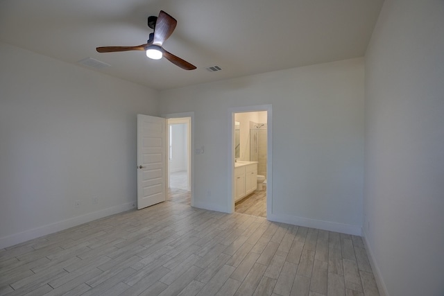 unfurnished bedroom with ceiling fan, light wood-type flooring, and ensuite bathroom