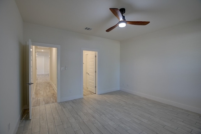 empty room featuring ceiling fan and light wood-type flooring