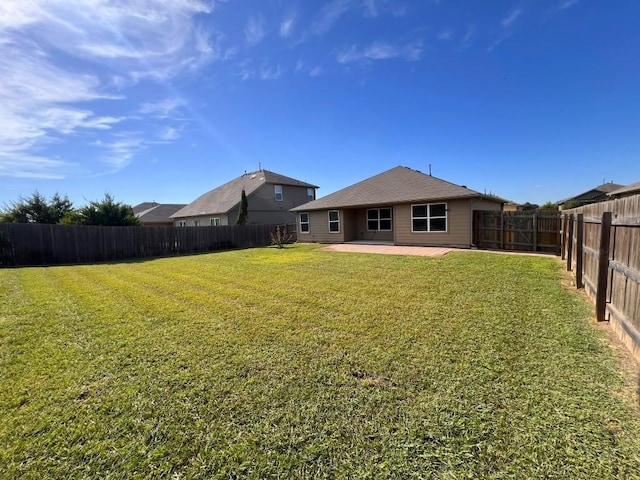 view of yard featuring a patio area and a fenced backyard