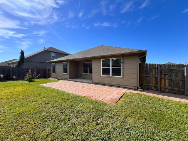 rear view of property with a patio and a yard