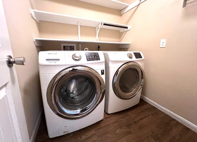 laundry room featuring dark hardwood / wood-style floors and washer and dryer