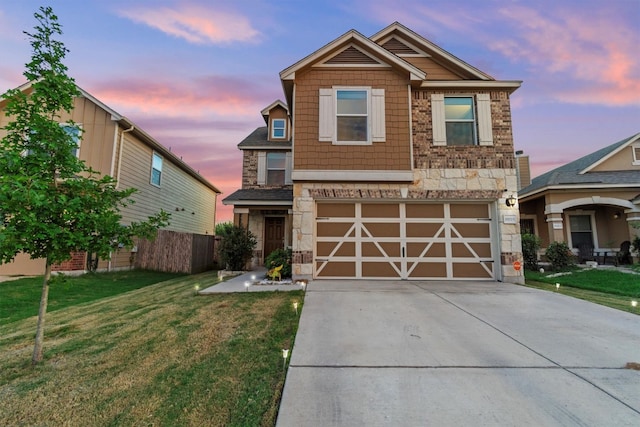 craftsman-style house featuring a lawn and a garage