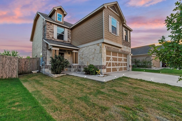 view of front of house featuring a lawn and a garage