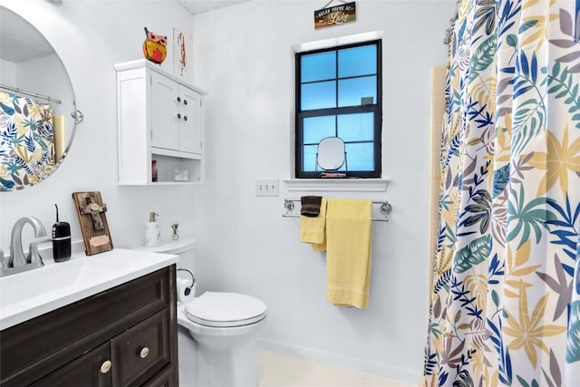 bathroom with tile patterned flooring, vanity, and toilet