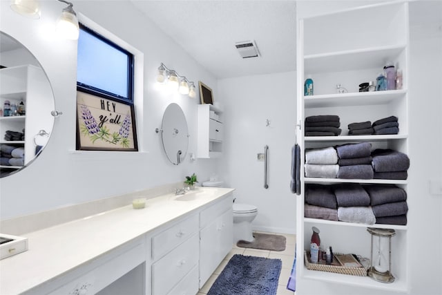 bathroom with tile patterned flooring, toilet, and vanity