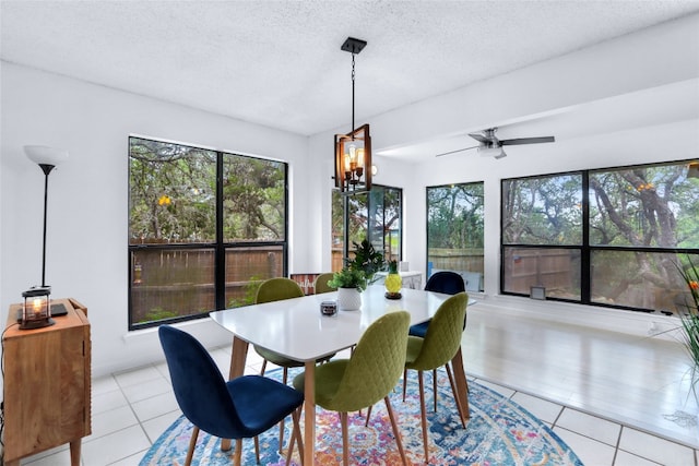 dining space with plenty of natural light, a textured ceiling, and light tile patterned flooring