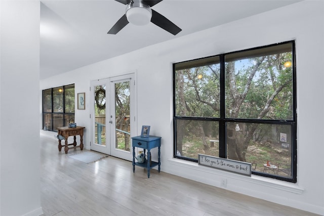 interior space with light hardwood / wood-style floors, french doors, and ceiling fan