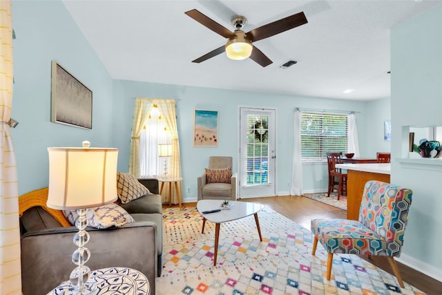 living room with ceiling fan and light wood-type flooring