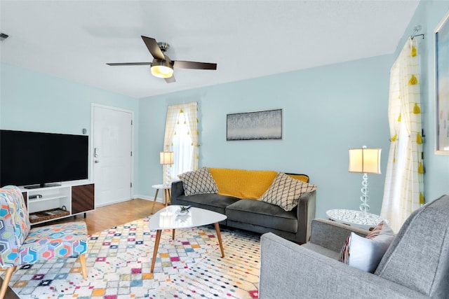 living room with ceiling fan and wood-type flooring