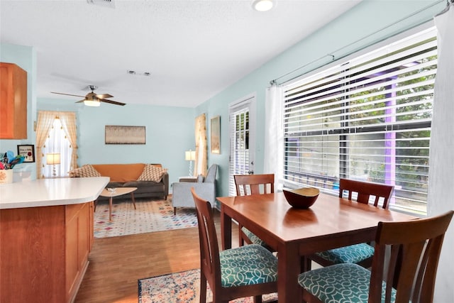 dining space featuring light hardwood / wood-style floors and ceiling fan