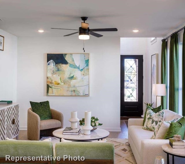 living room featuring ceiling fan and wood-type flooring