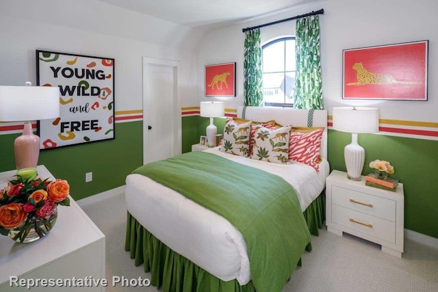 carpeted bedroom featuring vaulted ceiling