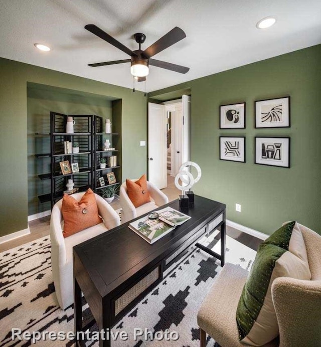 living room with ceiling fan and light wood-type flooring