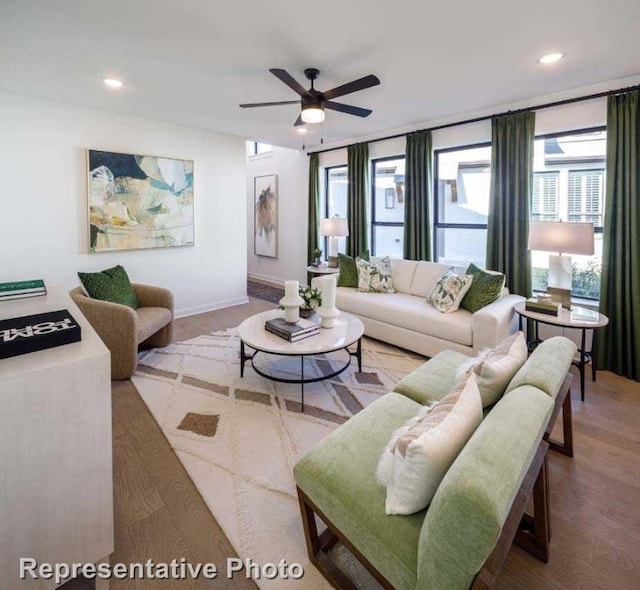 living room featuring wood-type flooring and ceiling fan