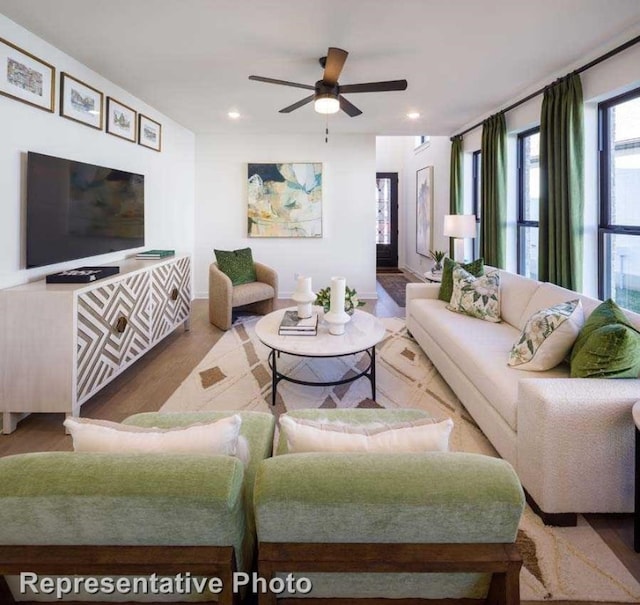 living room with ceiling fan and hardwood / wood-style floors