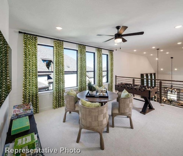 carpeted dining room featuring ceiling fan