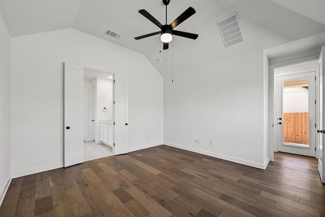 interior space featuring lofted ceiling, ensuite bath, dark hardwood / wood-style flooring, and ceiling fan