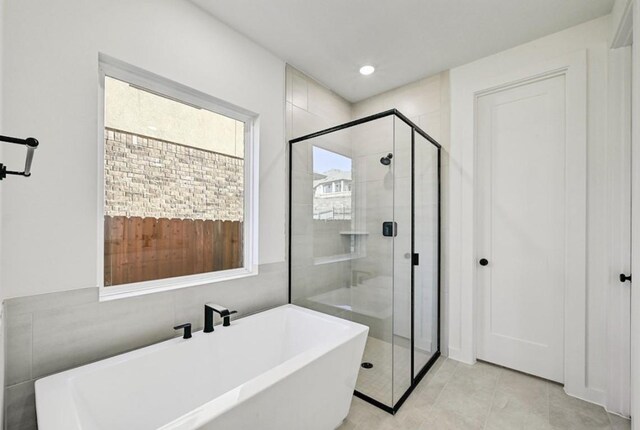 bathroom with tile patterned floors and plus walk in shower