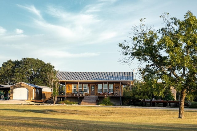 view of front of house featuring a garage, a front yard, and metal roof