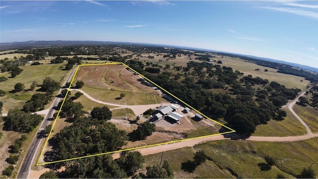 birds eye view of property with a rural view