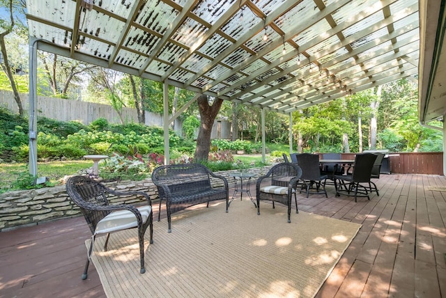 wooden deck featuring outdoor dining space and a pergola