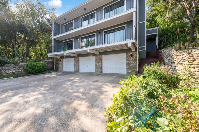 view of front of house with a balcony and a garage