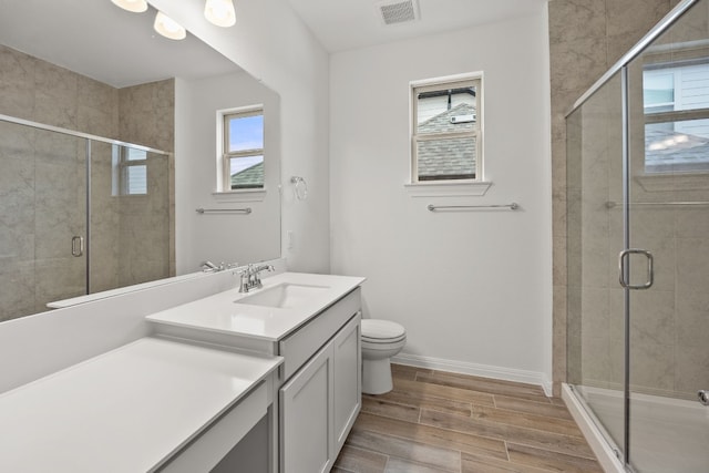 bathroom featuring a shower with shower door, wood-type flooring, and vanity