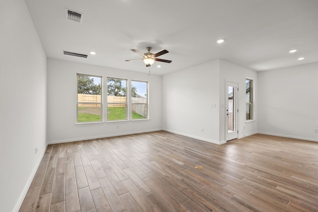 spare room with a ceiling fan, recessed lighting, visible vents, and wood finished floors