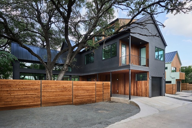 view of front of property with a balcony and a garage