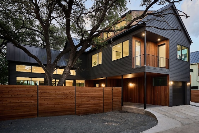 modern home with a balcony and a garage