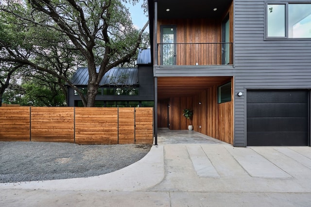 contemporary home with a garage and a balcony