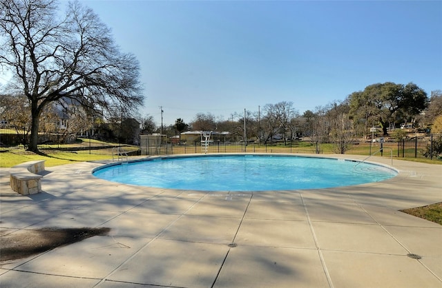 view of pool featuring a patio and a yard