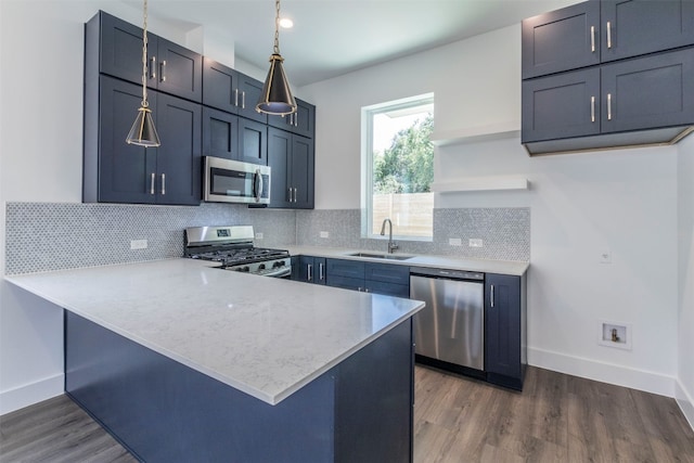 kitchen featuring dark hardwood / wood-style floors, sink, stainless steel appliances, and tasteful backsplash