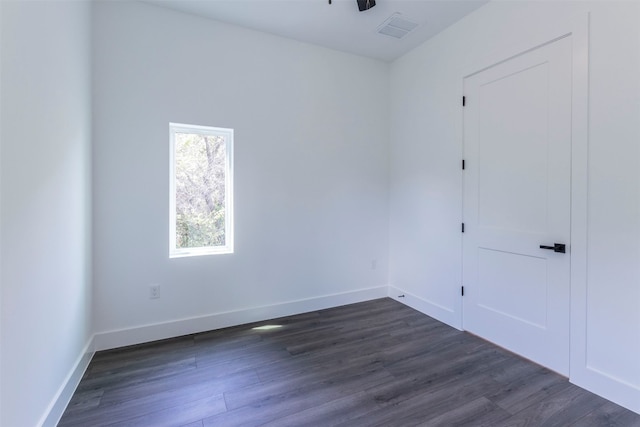 empty room featuring dark wood-type flooring