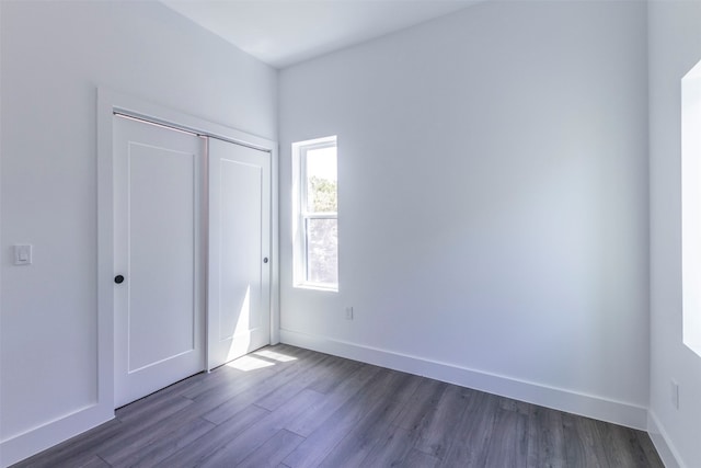 unfurnished bedroom with wood-type flooring and a closet