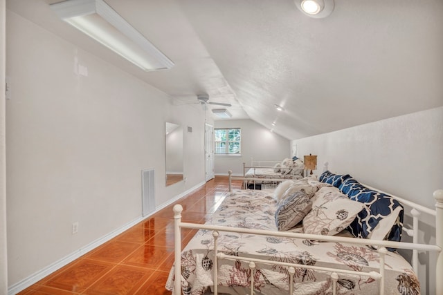 bedroom featuring tile patterned flooring, lofted ceiling, and ceiling fan