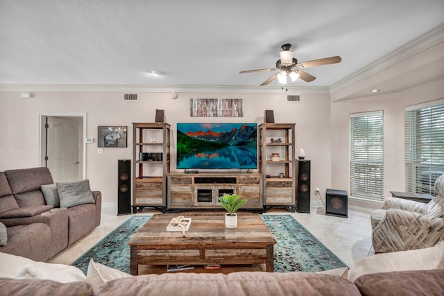 living room featuring a textured ceiling, ceiling fan, crown molding, and light tile patterned floors